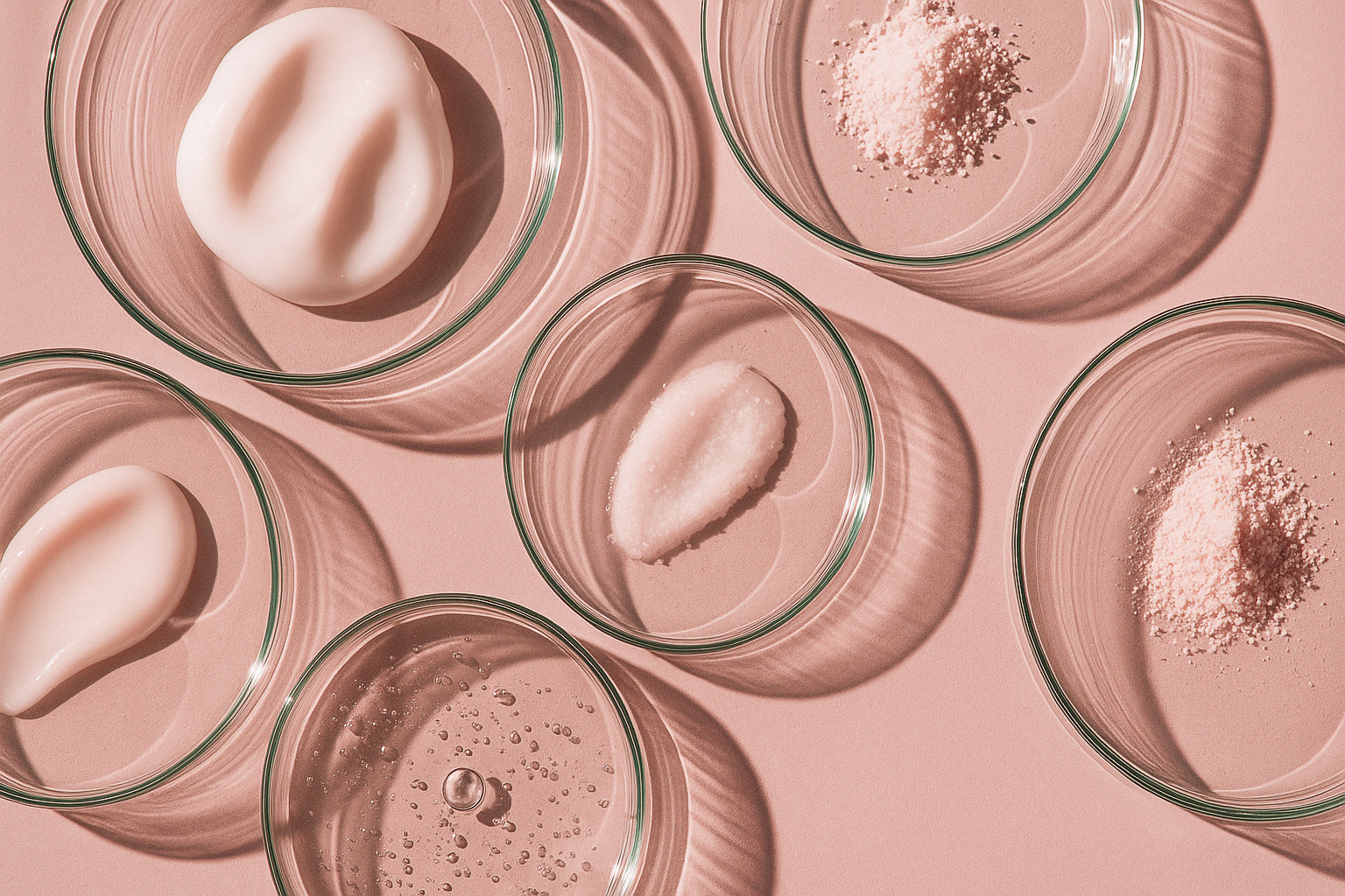 Glass petri dishes with active skincare ingredients, highlighting Blōma’s science-backed wellness formulation and clean, effective components.