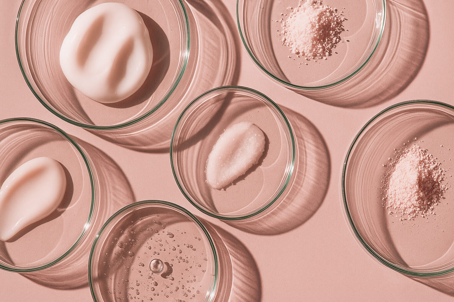 Glass petri dishes with active skincare ingredients, highlighting Blōma’s science-backed wellness formulation and clean, effective components.