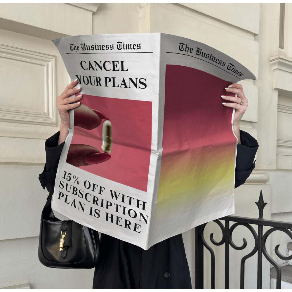 Person holding a newspaper featuring a Blōma Recovery Pack ad with “Cancel Your Plans” headline and a 15% off subscription offer. Bold promotional concept in a city setting.