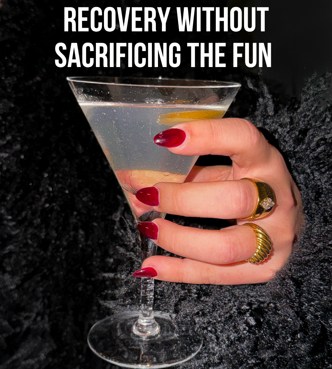 Close-up hand with red nails holding a martini with lemon twist, “recovery without sacrificing the fun.”